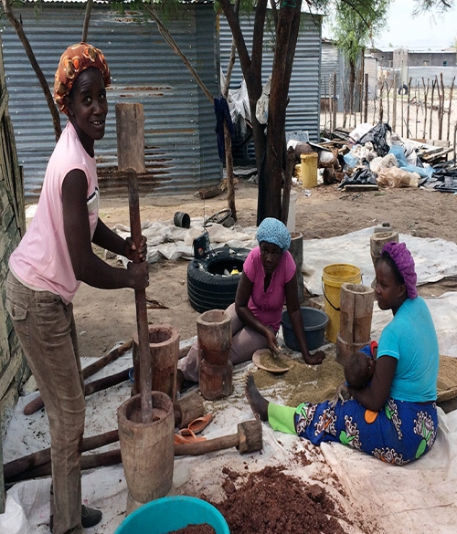 Women grinding the sorghum