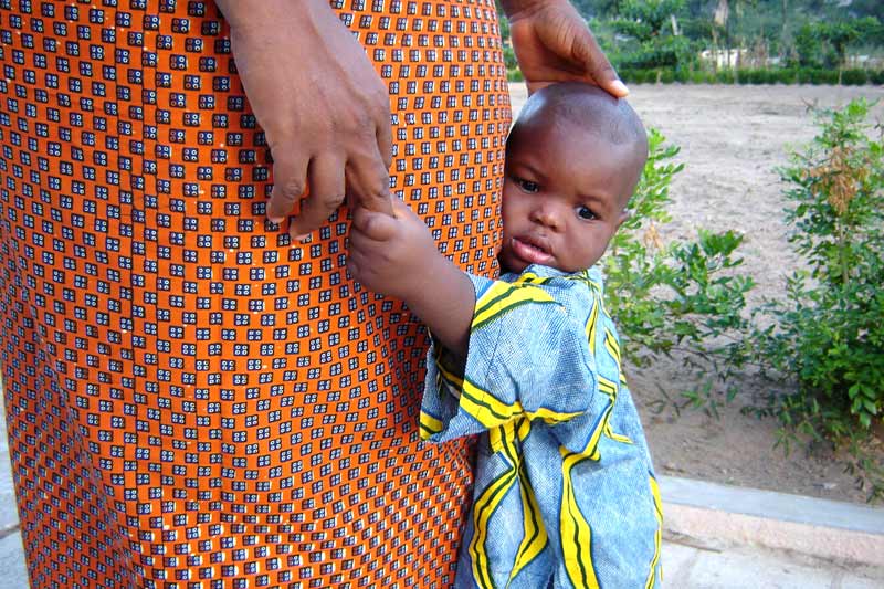 Sponsored child holding his SOS mother's hand in Benin