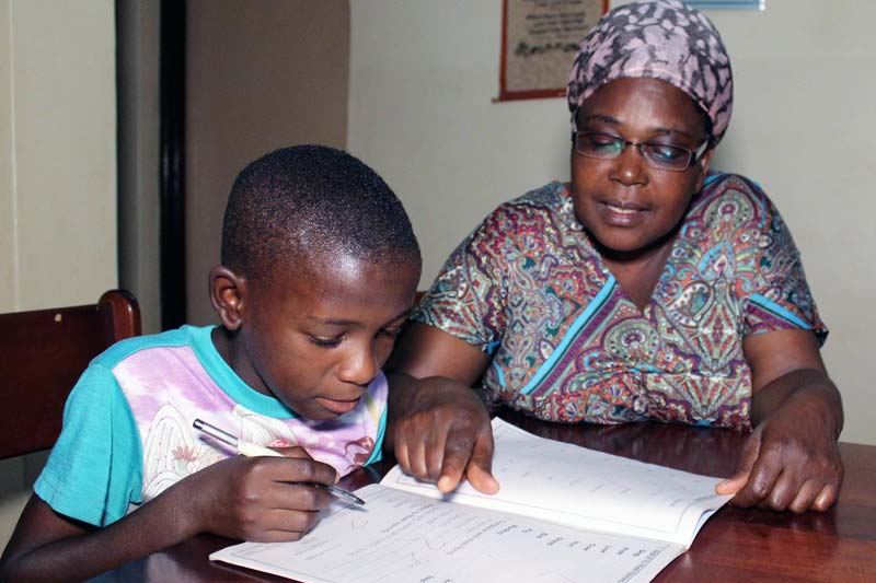 Mama Sarah with Achen doing homework