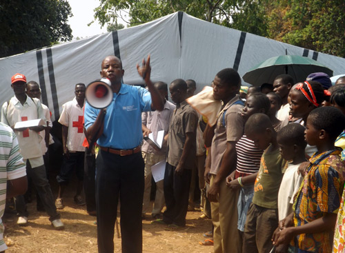 SOS staff member organizing a crowd using a loudspeaker