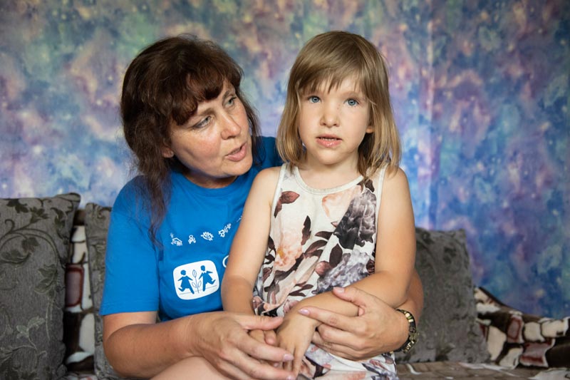 SOS worker with a young girl in Luhanska, Ukraine