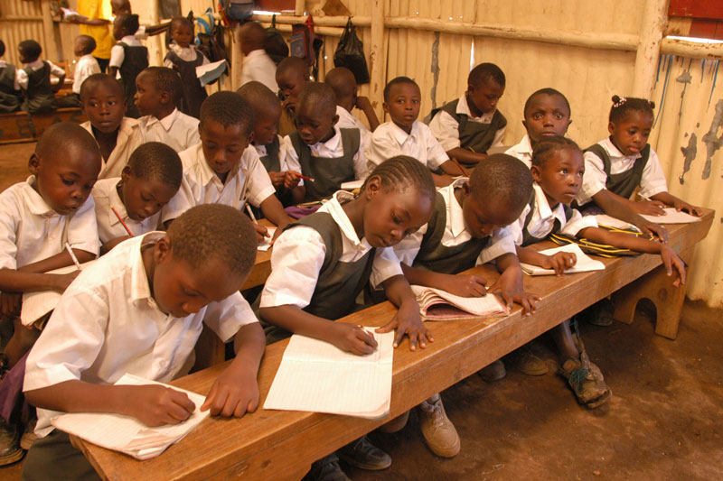 Students writing in classroom in Nairobi, Kenya