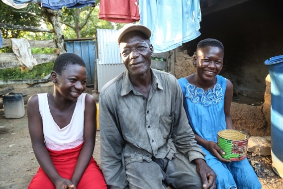 Nyaaba and two of his daughters pose for a picture.