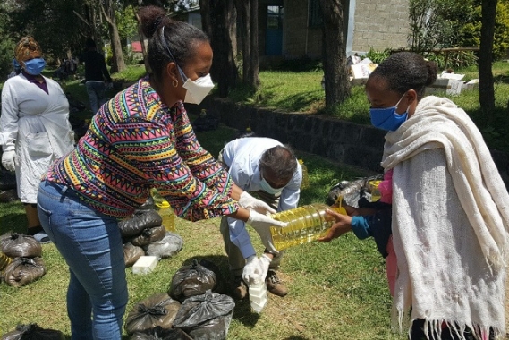 SOS workers distribute relief packages to needy recipients.