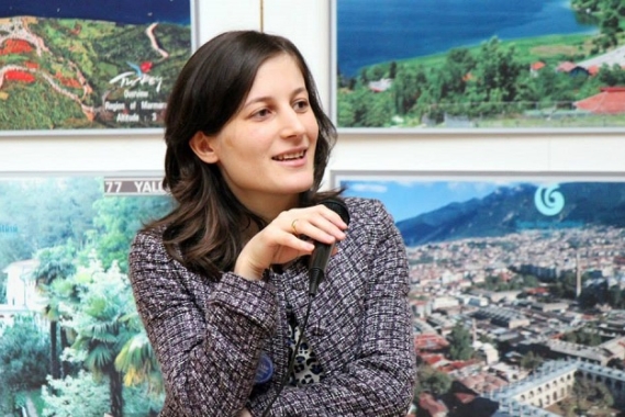Nelly Akobia speaking during a presentation.