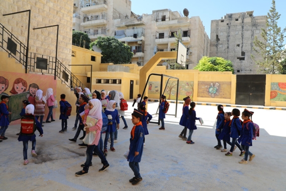 Children outside rebuilt school in Aleppo Syria