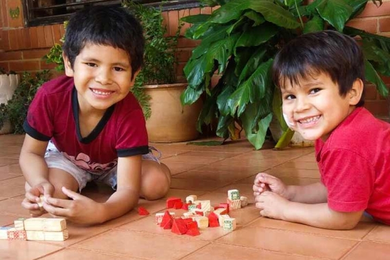 Two boys plaing on the floor in San Ignacio, Paraguay