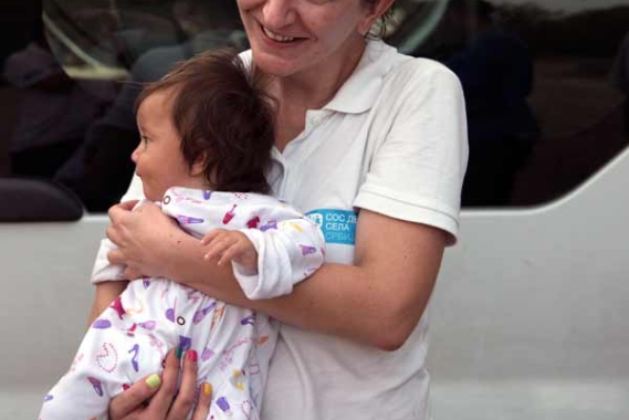 Katerina Ilievska holding infant migrant in Serbia