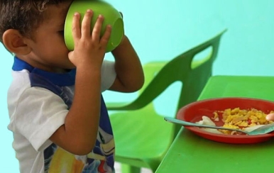 Child enjoying a nutritious meal in an SOS child-friendly space.