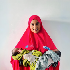 nurse in Somalia holding two newborns