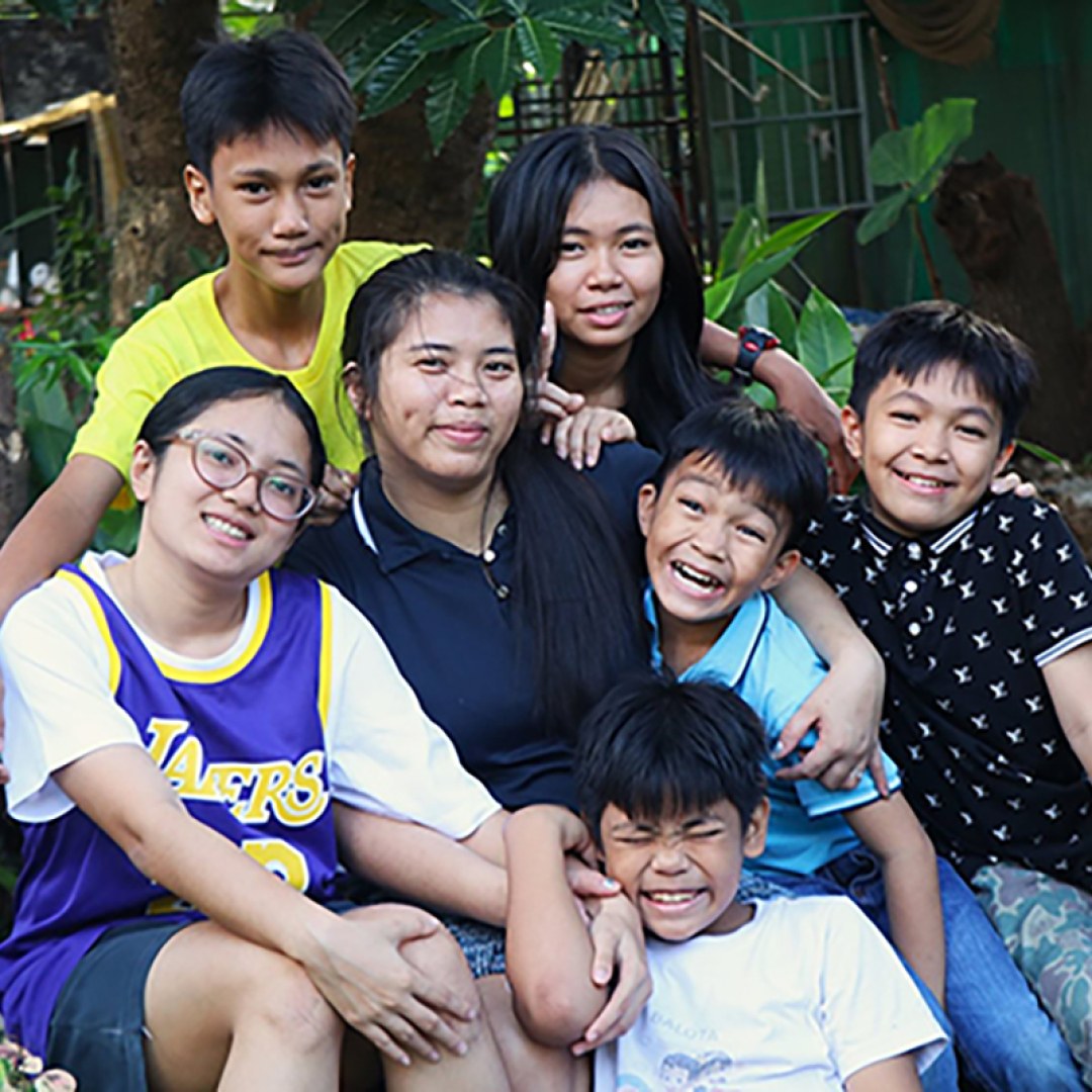 SOS mother and her six children outside their home in the Philippines.