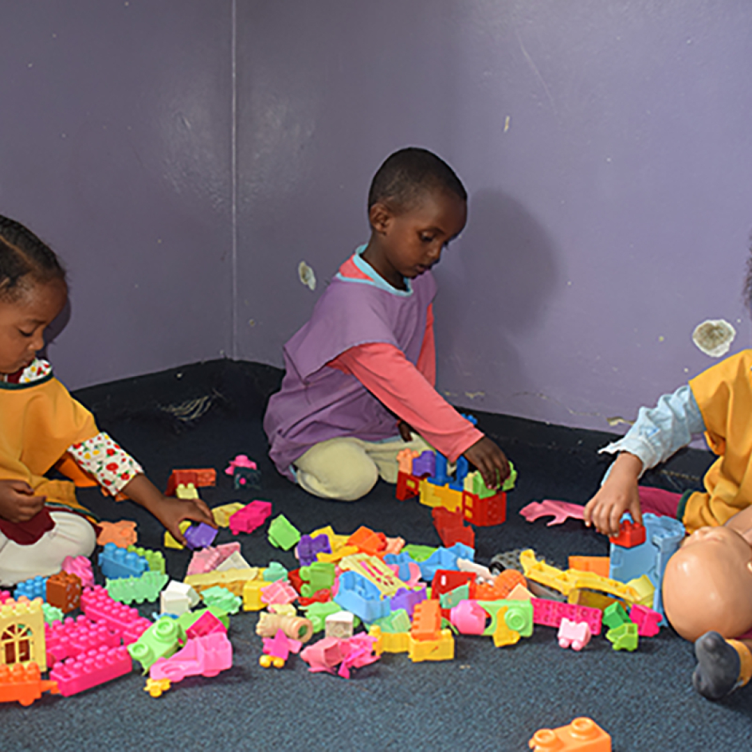 Young children playing and learning with building blocks at an early childhood development centre in Ethiopia