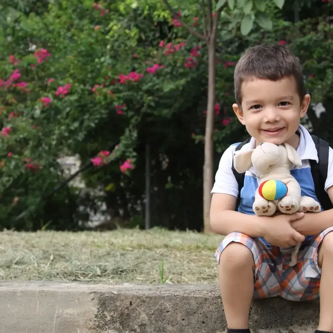 A boy holding a stuffed animal