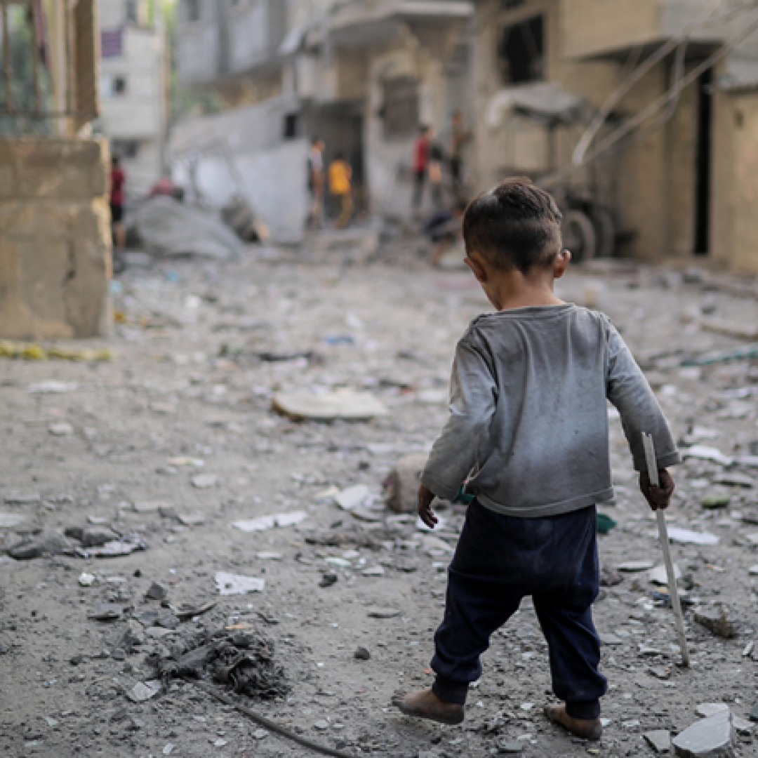 A boy walking through the streets in Gaza