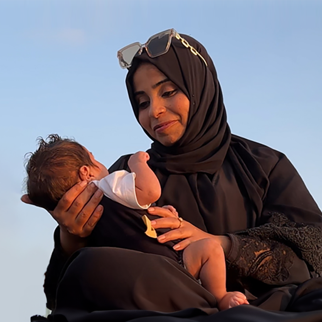 A mother holding her young child in Palestine