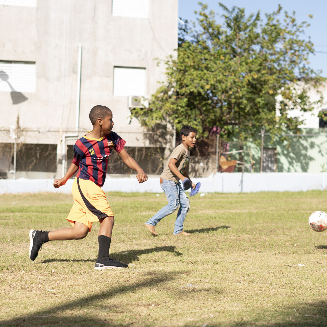 A group of children playing soccer in the Dominican Republic.