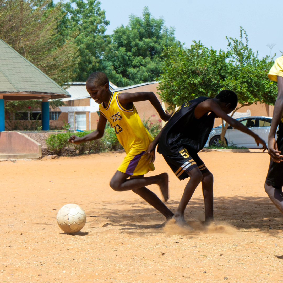 A group of children playing soccer in Senegal.