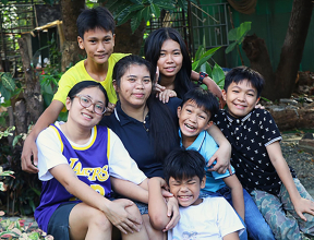 SOS mother and her six children outside their home in the Philippines.