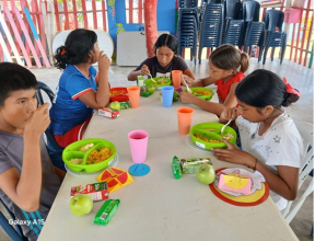 Children eating a nutritious snack at an SOS Children’s Villages child-friendly space in Colombia.  