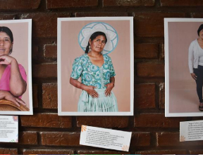 Artwork of Bolivian mothers hanging on a brick wall
