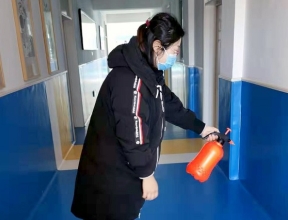 A woman disinfects an SOS school.
