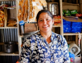 Sumitra smiling in her small business.