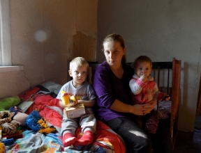 Anastasia with her children in a temporary shelter.