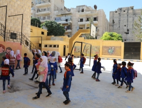 Children outside rebuilt school in Aleppo Syria