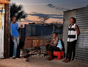 Young mother with siblings at home in Ondangwa, Namibia.