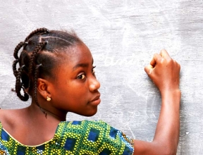 Girl writing on blackboard in Niger