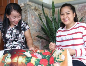 Daughter sewing with her SOS mother