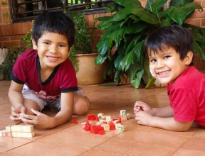 Two boys plaing on the floor in San Ignacio, Paraguay
