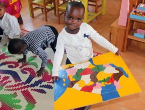 Child holding map of Tanzania - Sponsor a child in Tanzania