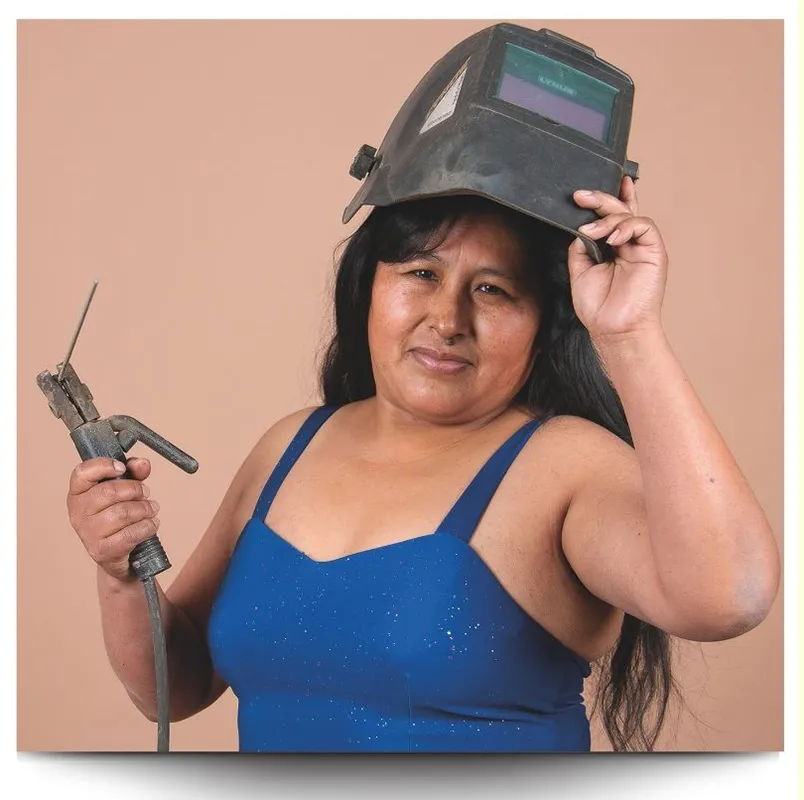 A Bolivian woman holding a welding tool