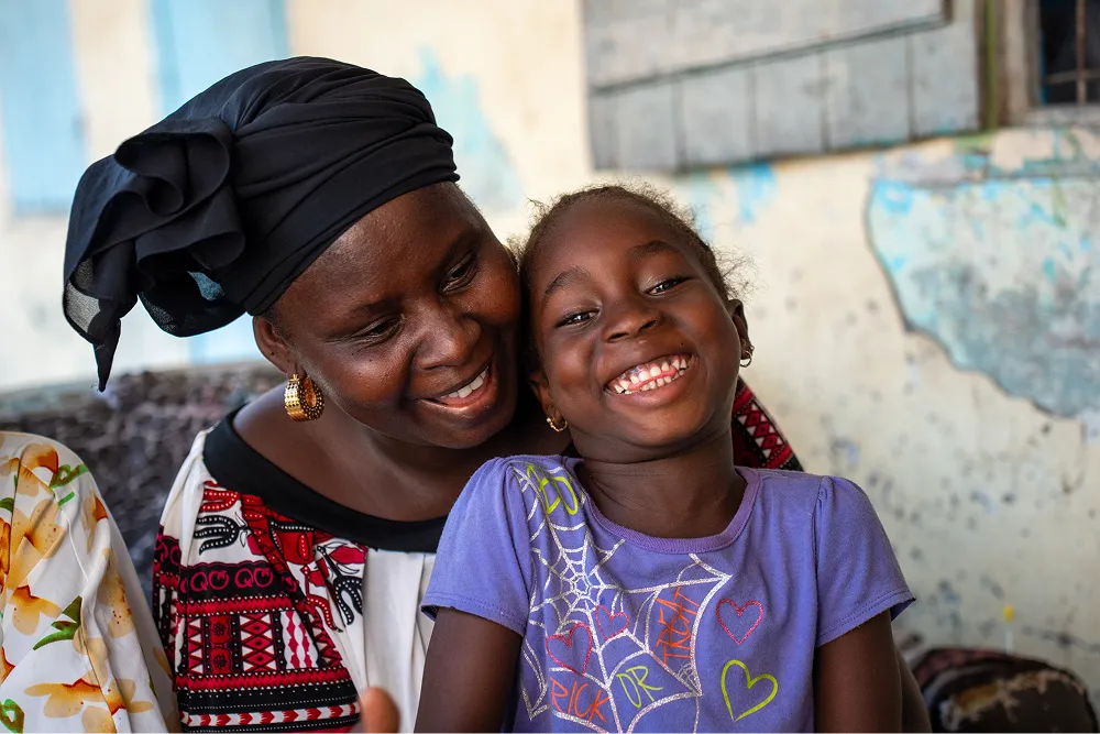 A woman and a child sitting and laughing together