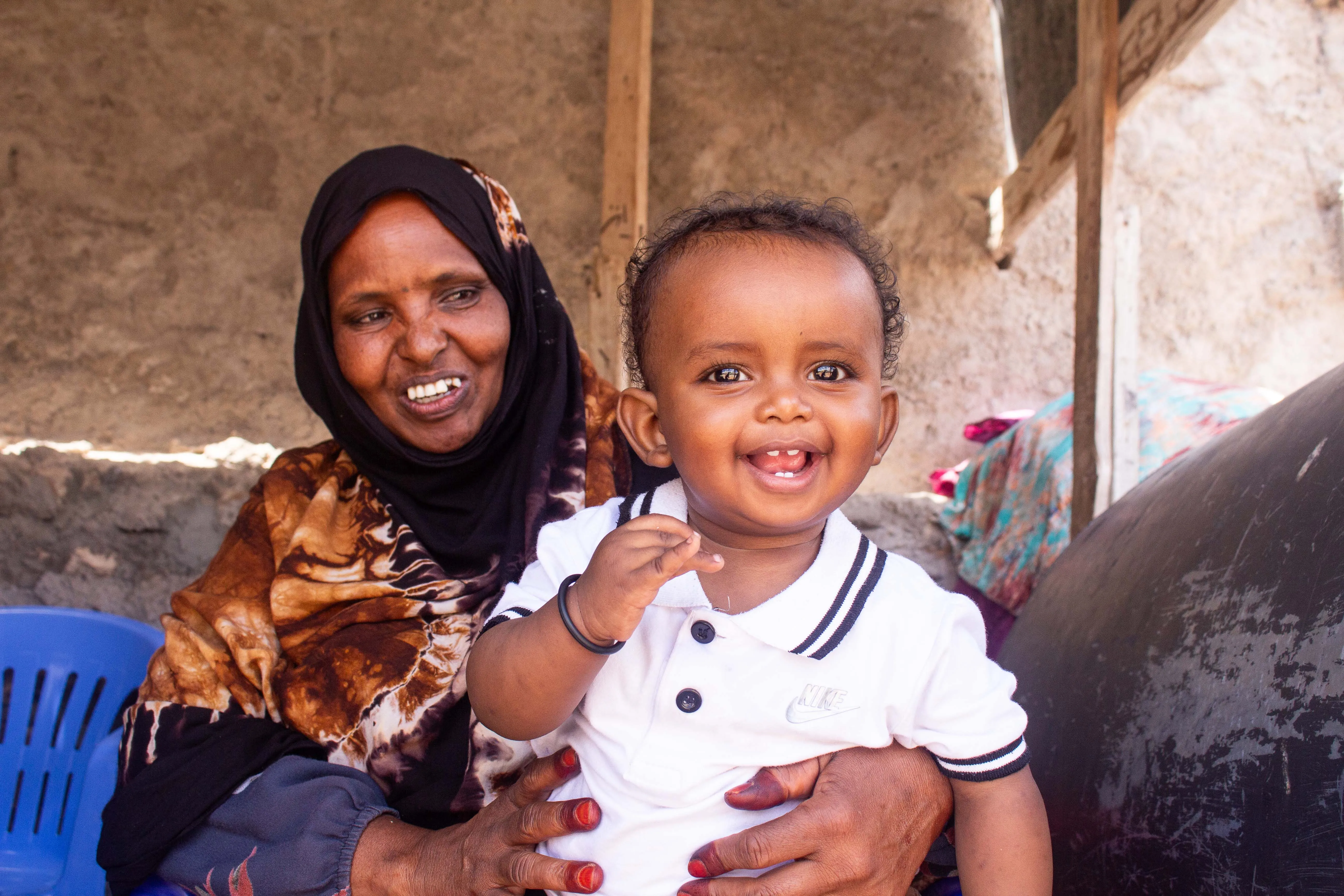 mother holding her young child in Hargeisa, Somaliland, both are smiling.