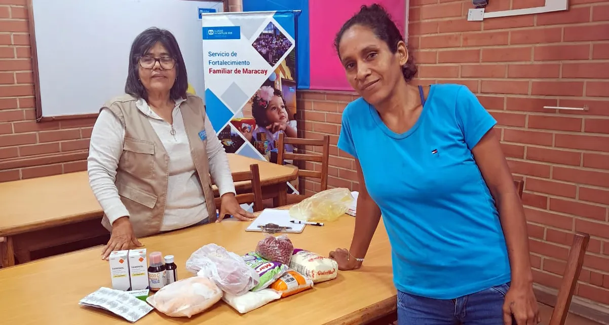 A woman receives food, hygiene supplies and medicines from SOS Children's Villages Venezuela after the earthquakes.