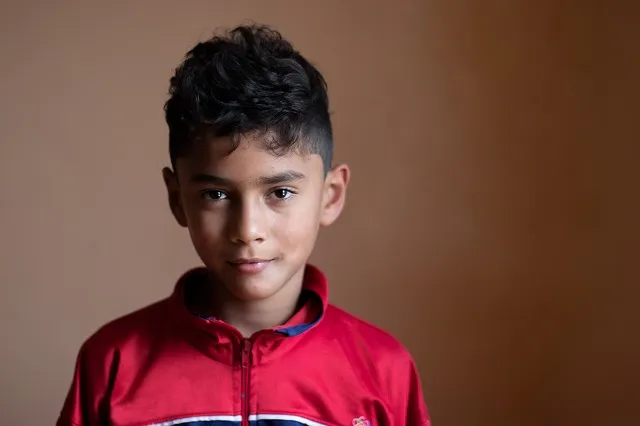 An SOS child looking sombre.