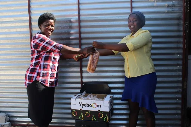 Sanna selling fresh bread to a customer