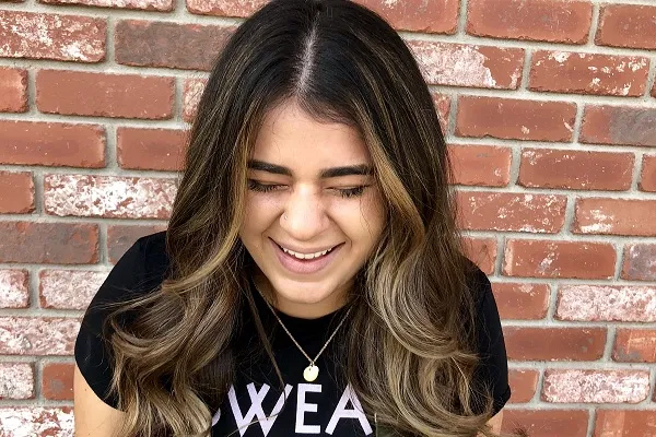 Taylor in front of a brick wall