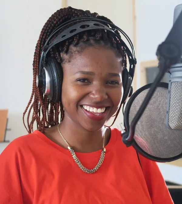 Tumi smiling in the recording studio.
