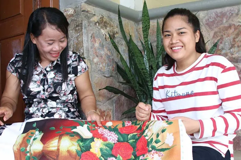 Daughter sewing with her SOS mother