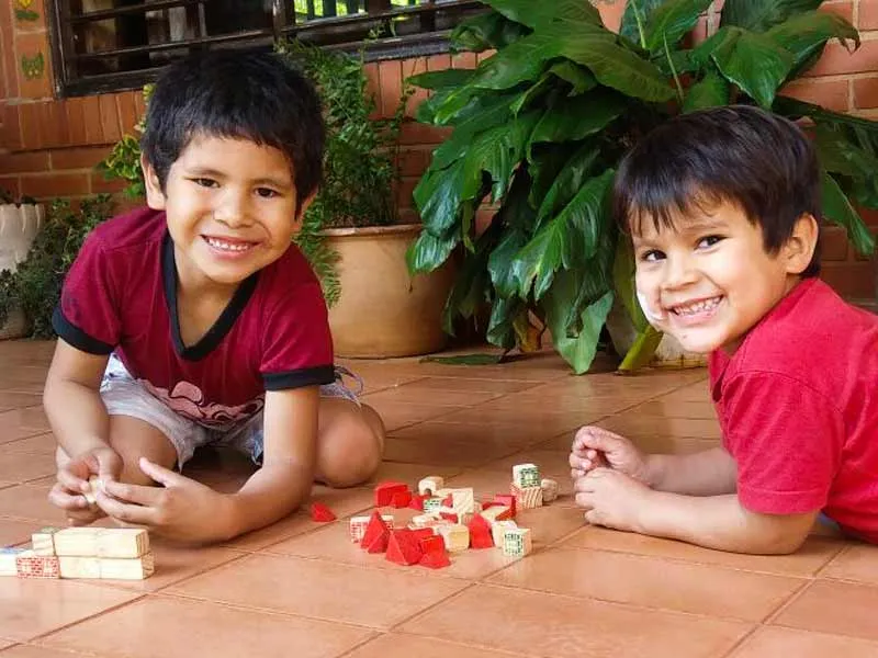 Two boys plaing on the floor in San Ignacio, Paraguay