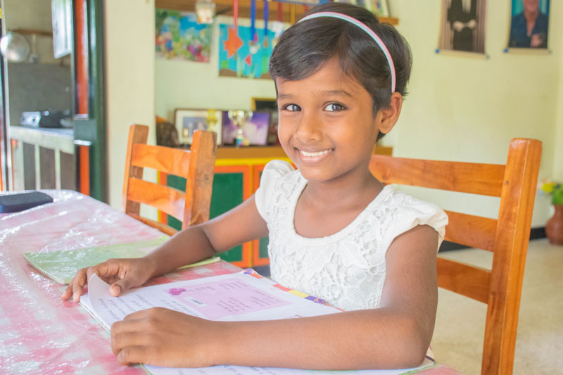 Tharushi working on her school work