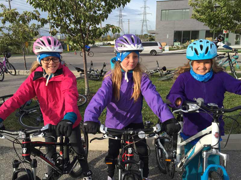 Three girls on bikes