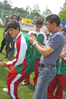 Krassmir Balakov signing SOS child's soccer jersey