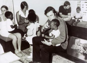 Johnny Cash at an SOS Children's Village helping feed a child