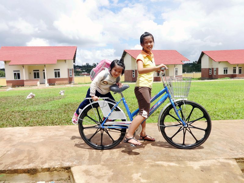 SOS sisters riding bike to school in Pleiku, Vietnam