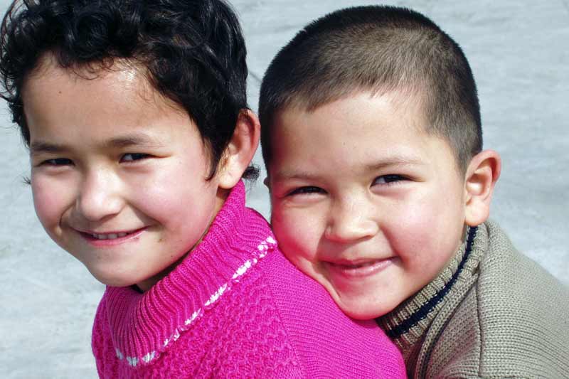 Two children smiling in Urumqi, China