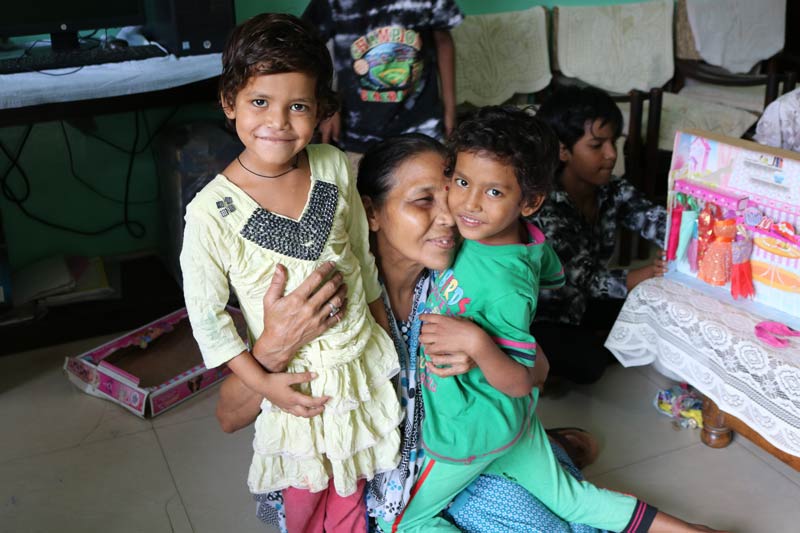 SOS mother hugging sisters
